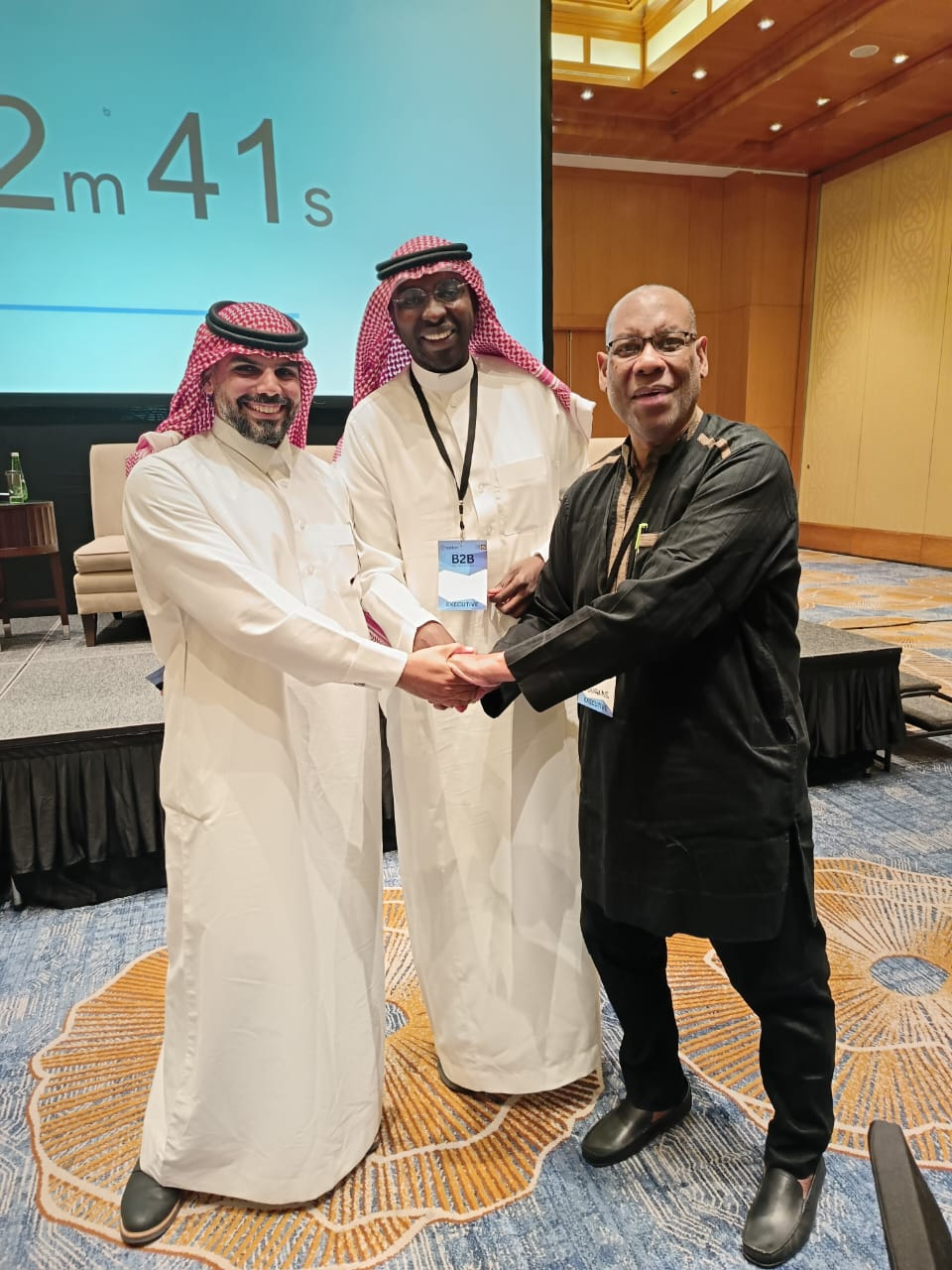 UCII Founder Douglas Owen-Ali shaking hands with Gulf partners at a cross-border investment forum